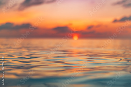 Slika na platnu Radiant tranquil sunset ocean closeup with colorful reflections calm water surface serene relaxing seascape nature background
