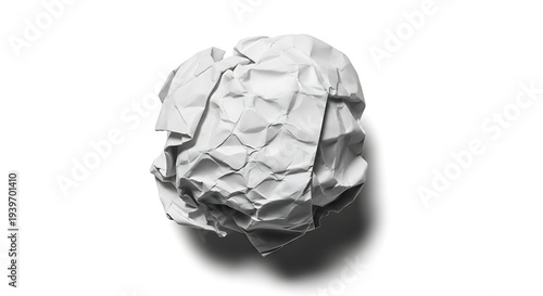 Crumpled paper ball on white surface with shadow from overhead viewpoint