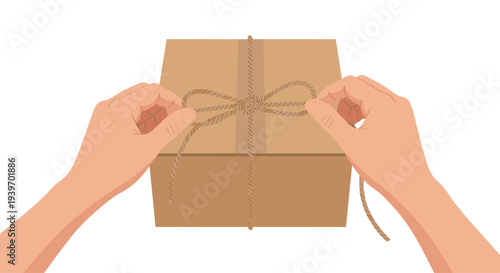 Two light-skinned hands are meticulously tying a brown twine into a decorative bow on the top surface of a rectangular brown cardboard box.
