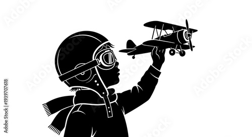 Silhouette of a child wearing vintage aviator helmet and goggles holding a biplane toy dreaming of flight and adventure