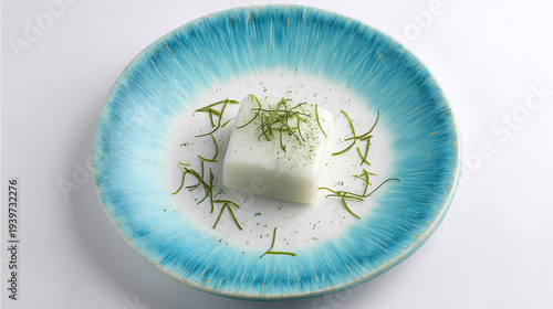 White Soap Bar with Herbs on Blue Plate