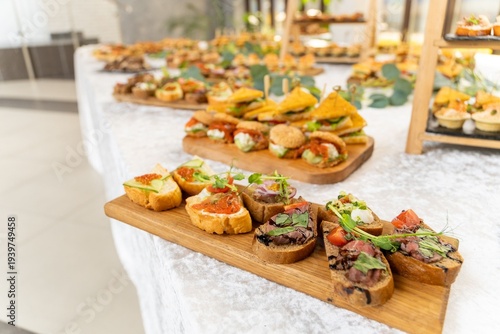 Gourmet buffet table with assorted bruschetta, canape and mini sandwich