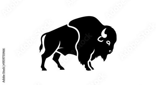 Black silhouette of a bison standing.