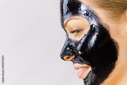 Foto Woman with black peel off mask on face