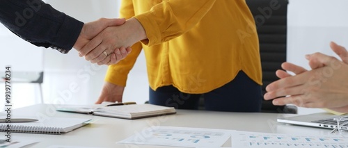 Tableau sur toile Professional businesspeople shaking hands, confirming partnership agreement in contemporary corporate sunny office