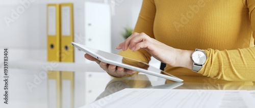 Bilde på lerret Woman freelancer working with digital tablet, browsing information, using online technology in modern office