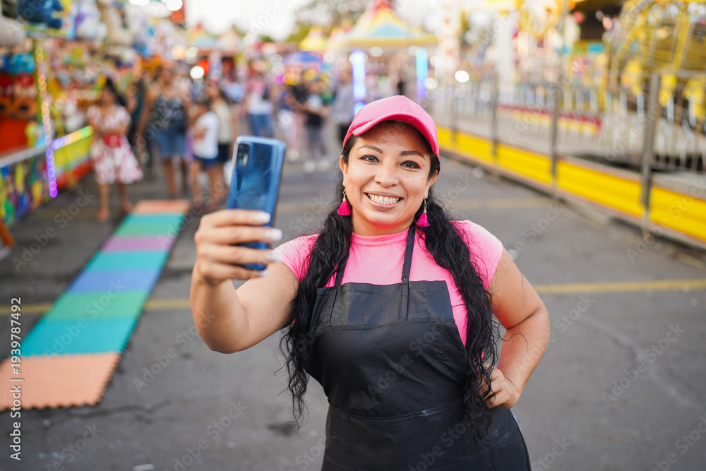 Fototapeta premium Latin woman entrepreneur making selfie at business fair
