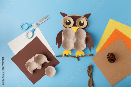 Diy owl craft made from recycled egg carton colored paper scissors on blue background. Great for primary school education art therapy preschool activity eco friendly hobbies and blog content