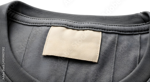 Close-up of a blank clothing label sewn onto the inside seam of a dark grey t-shirt, ready for branding or care instructions