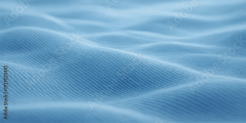 A closeup macro of soft blue silk and satin fabric creates a light winter wave pattern with a smooth textile material texture