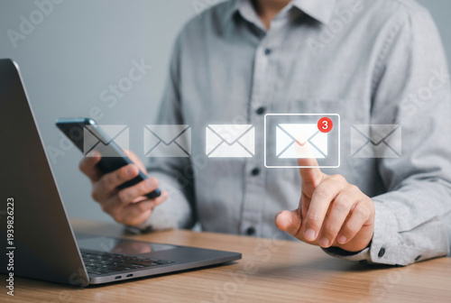 Wallpaper Mural Man Using Laptop and Smartphone Interacting with Virtual Email Icons and Notifications Torontodigital.ca