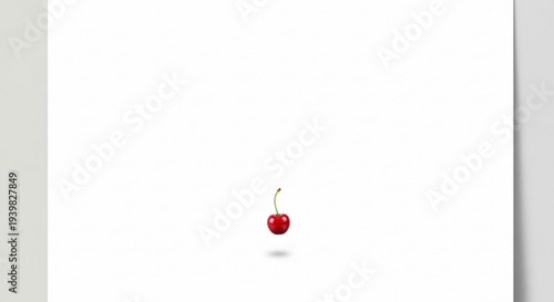 A single ripe red cherry with green stem on white background simple still life composition