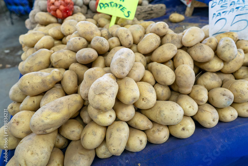 Close-up of washed fresh potatoes for sale on a market stall