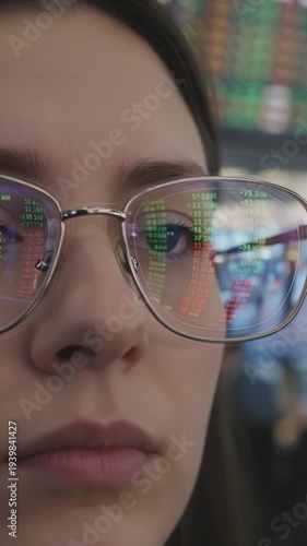 Woman Wearing Glasses Reflects Stock Market Data