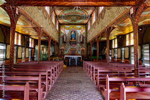 Interior of Saint-Joseph d'Iracoubo church, French Guiana. Famous hand-painted frescoes by a convict, unique wooden architecture in South America.