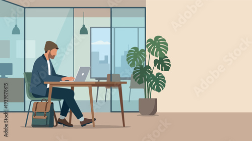 Man working on laptop in modern office setting.