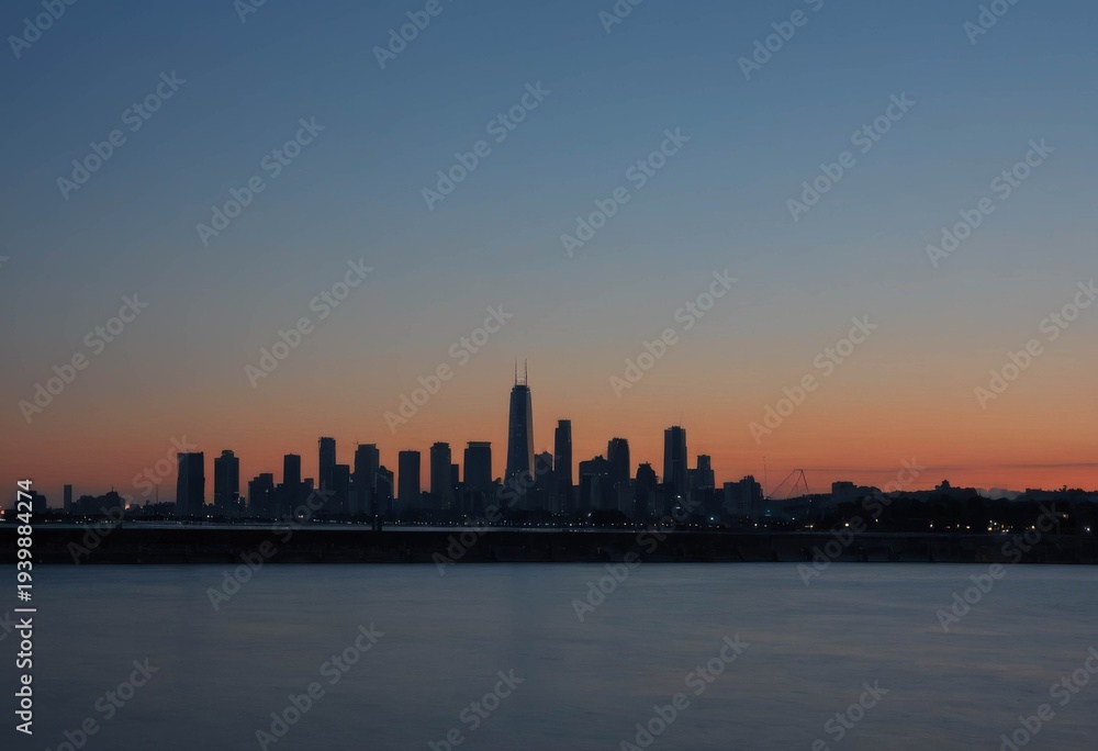 Fototapeta premium Silhouette of City Skyline with Water Reflection