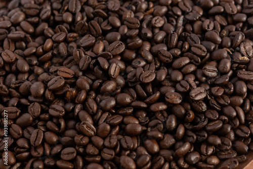 Coffee beans photographed from above, with a shine. No people, horizontal image