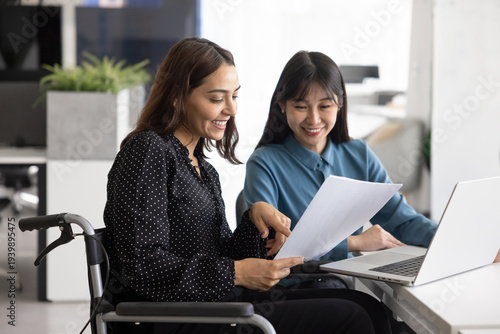 Photos Happy young female legal or financial expert in wheelchair explaining text of do