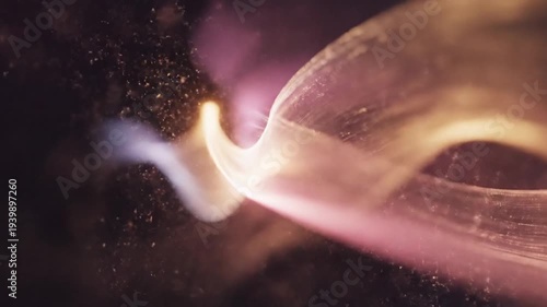 Abstract glowing wavy lines with particles on dark background