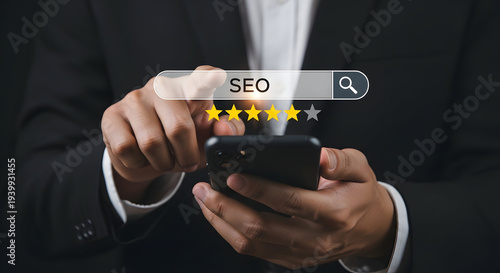 Hands holding smartphone with S E O search bar and five star rating