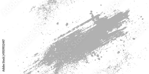 Abstract gray paint stroke against a plain background, the brushstroke showcases texture and abstract artistry, with splatters of paint adding depth to the visual display.