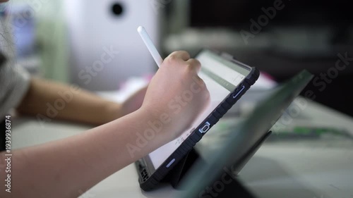 closeup tablet and hand of young child study online or kid student write learning on computer laptop by touch pen and touch screen with doing homework or people writing to learn from home school