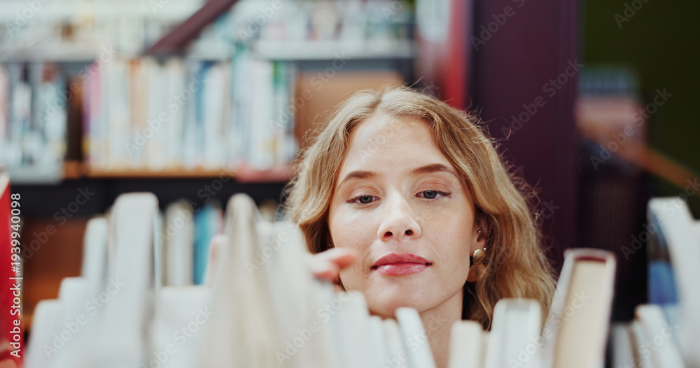 Fototapeta premium Student, girl and search on bookshelf at college for book choice, pick textbook and knowledge. University, person and check course resources in library for study research, thesis citation or learning
