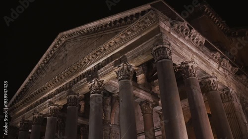 Night view of the Pantheon, illuminated against a deep black sky in the heart of the historic city.  Rome, Italy 4K