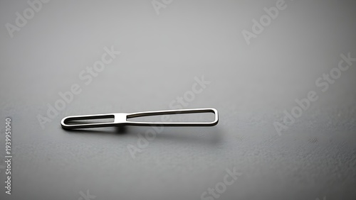 Tuning fork resting on textured surface after being struck, motion blur. STEM education sheets, lab safety posters, designed for biotech research communications.