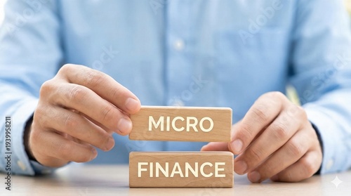 Businessman holding wooden blocks with micro finance text