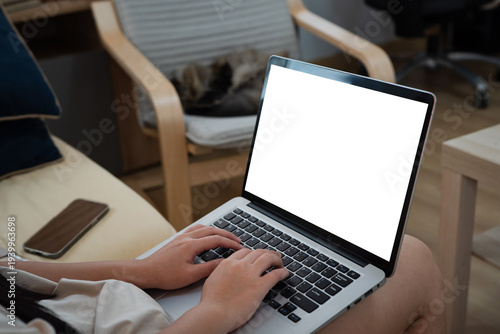 Fotografía Young woman using laptop computer at home