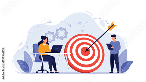 Business team working together on laptop to hit sales targets and achieve goals represented by large bullseye and arrow.