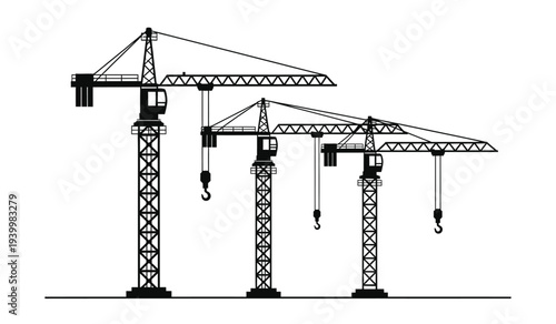Three construction cranes standing in a row with hooks