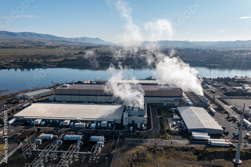 Obraz na płótnie Aerial drone picture of a large data center campus with cooling steam, electrical substation along the Columbia River in The Dalles, Oregon, USA