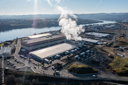 Aerial drone picture of a large data center campus with cooling steam, electrical substation along the Columbia River in The Dalles, Oregon, USA. Power demand for cloud computing AI infrastructure
