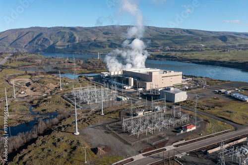 Aerial drone picture of a large data center campus with cooling steam, electrical substation along the Columbia River in The Dalles, Oregon, USA. Power demand for cloud computing AI infrastructure