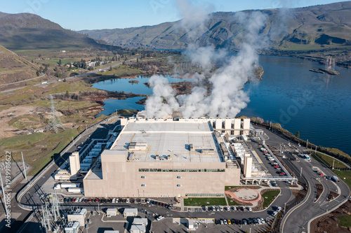 Aerial drone picture of a large data center campus with cooling steam, electrical substation along the Columbia River in The Dalles, Oregon, USA. Power demand for cloud computing AI infrastructure