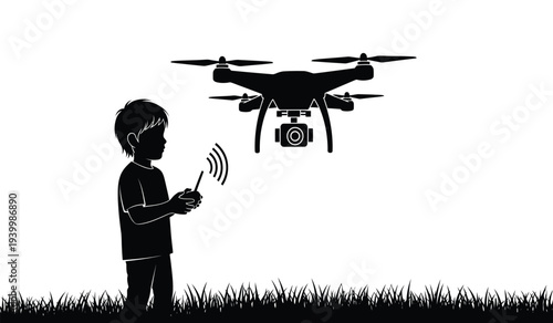 Silhouette of a boy operating a drone with a remote control in a grassy field