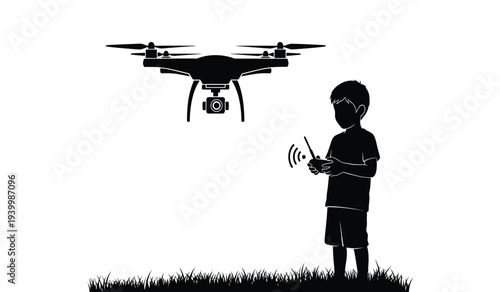 Young boy operating a drone with a remote control standing on grassy ground