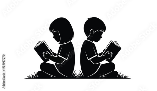 Two children sitting on grass reading books in silhouette