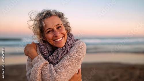 Hopeful Middle Aged Woman Standing on Beach Embracing Herself and Smiling Toward the Sea Symbolizing New Beginnings and Meaningful Living