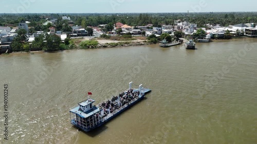 Cao Lanh City, Dong Thap, Southwest Vietnam – 4K aerial drone footage of ferry boats crossing the Mekong River with riverside houses and rural delta landscape