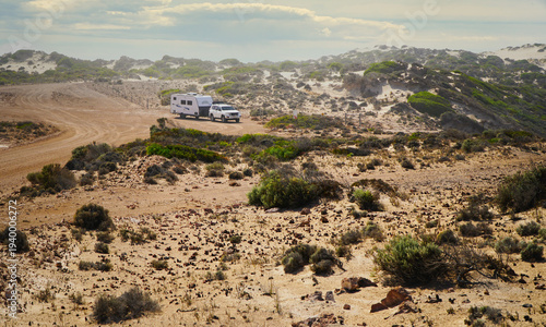 Four-Wheel drive and caravan parked on sandy coastal dunes in South Australia during a road trip