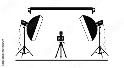 A studio setup featuring two softbox lights a camera on a tripod and a boom arm presented as a silhouette