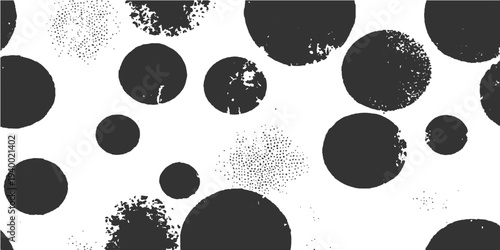 Abstract pattern of scattered black circles on a neutral surface, evoking a sense of modern simplicity and artistic expression.