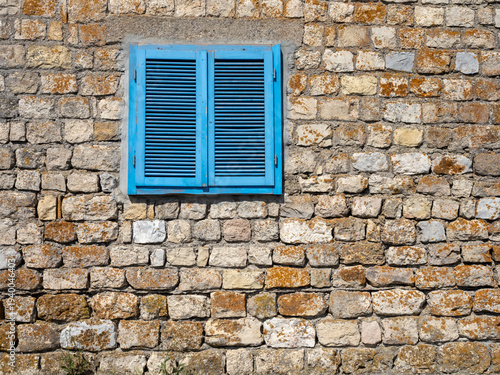 Blue Wooden Shutters on Old Stone Wall in Dobrogea