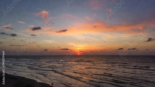 Sun dips low, painting sky in orange and purple