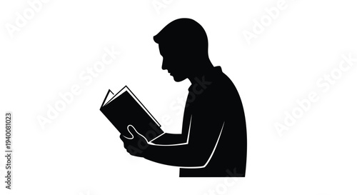 Silhouette of a person intently reading an open book in profile