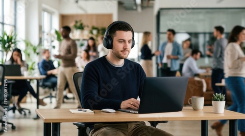 Professional man wearing noise-canceling headphones in busy office